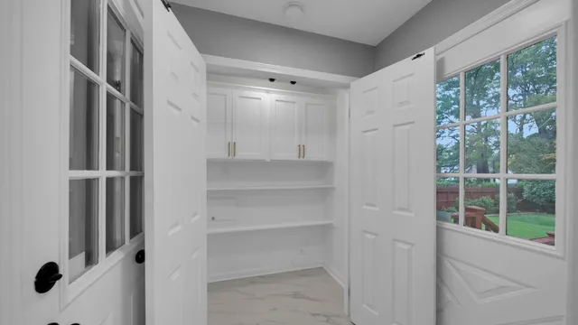 a view of walk in closet with empty racks