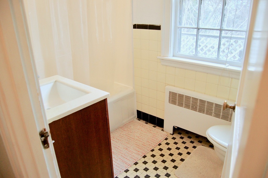 29 Pierrepont Road Newton, MA 02462 - Photo 14 of 20 a bathroom with a sink and a mirror