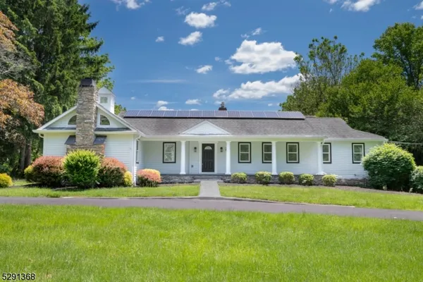 a front view of a house with a garden and plants