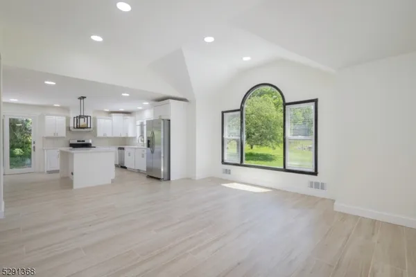 a view of a room with window and wooden floor