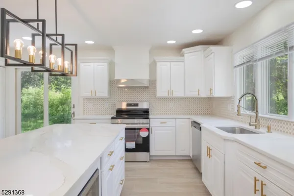 a kitchen with a sink stove and cabinets