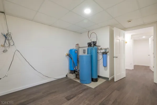 a view of a room with wooden floor and furniture
