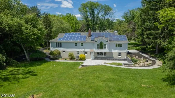 a front view of a house with a yard table and chairs