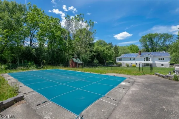 a view of a swimming pool with a yard