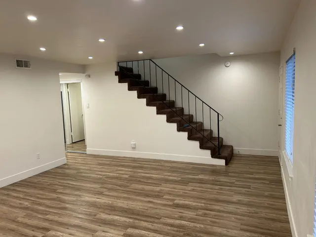 a view of entryway and hall with wooden floor