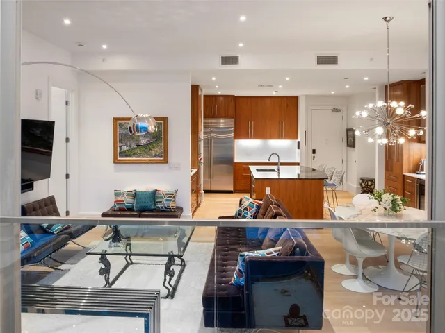a kitchen with stainless steel appliances kitchen island granite countertop a sink and a stove
