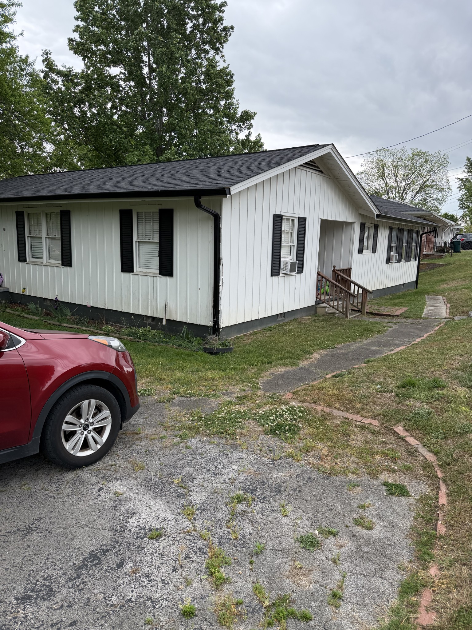 901 East College Street Pulaski, TN 38478 - Photo 3 of 20 a front view of a house with a garden and parking space