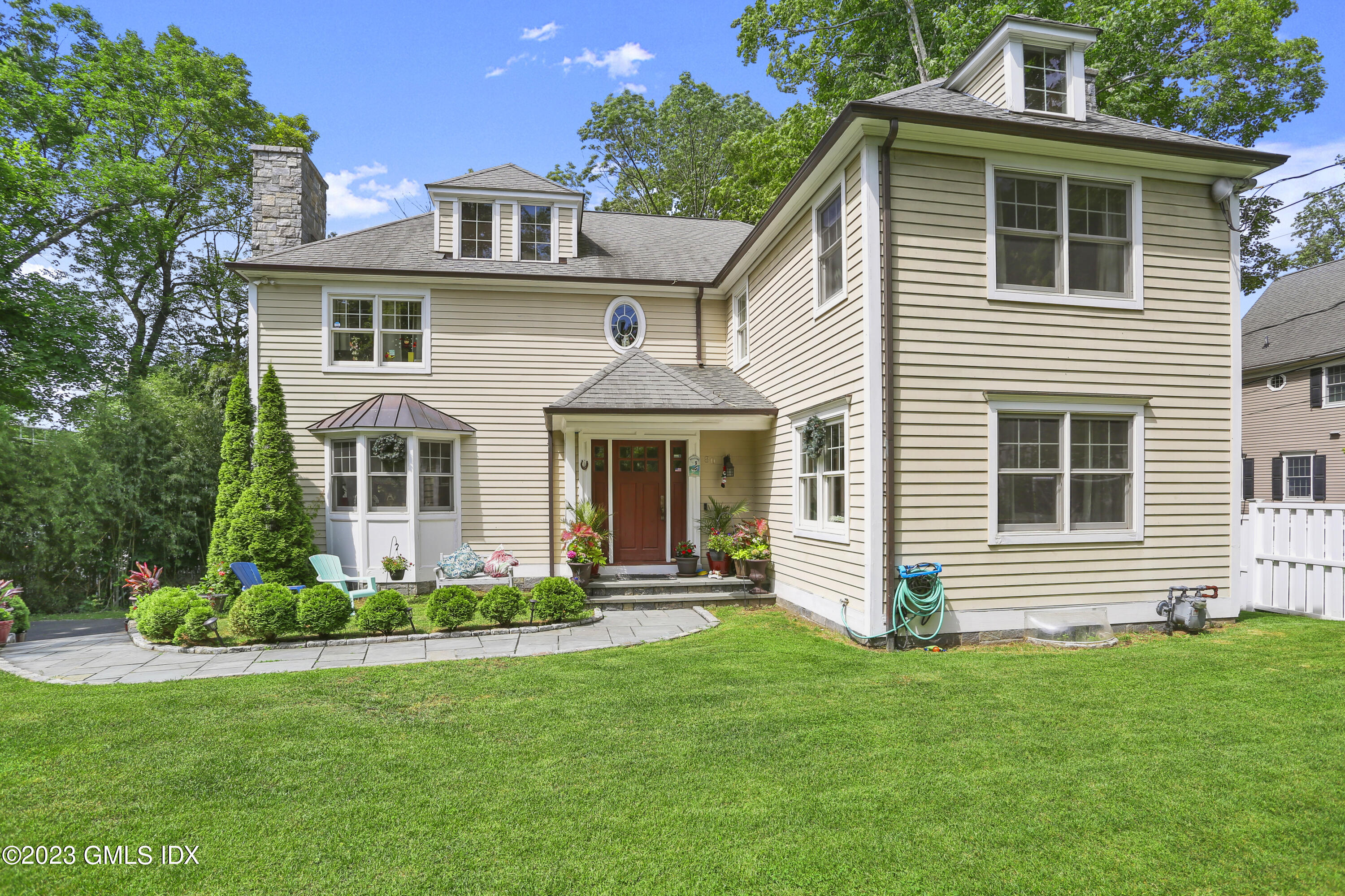 a front view of a house with a garden