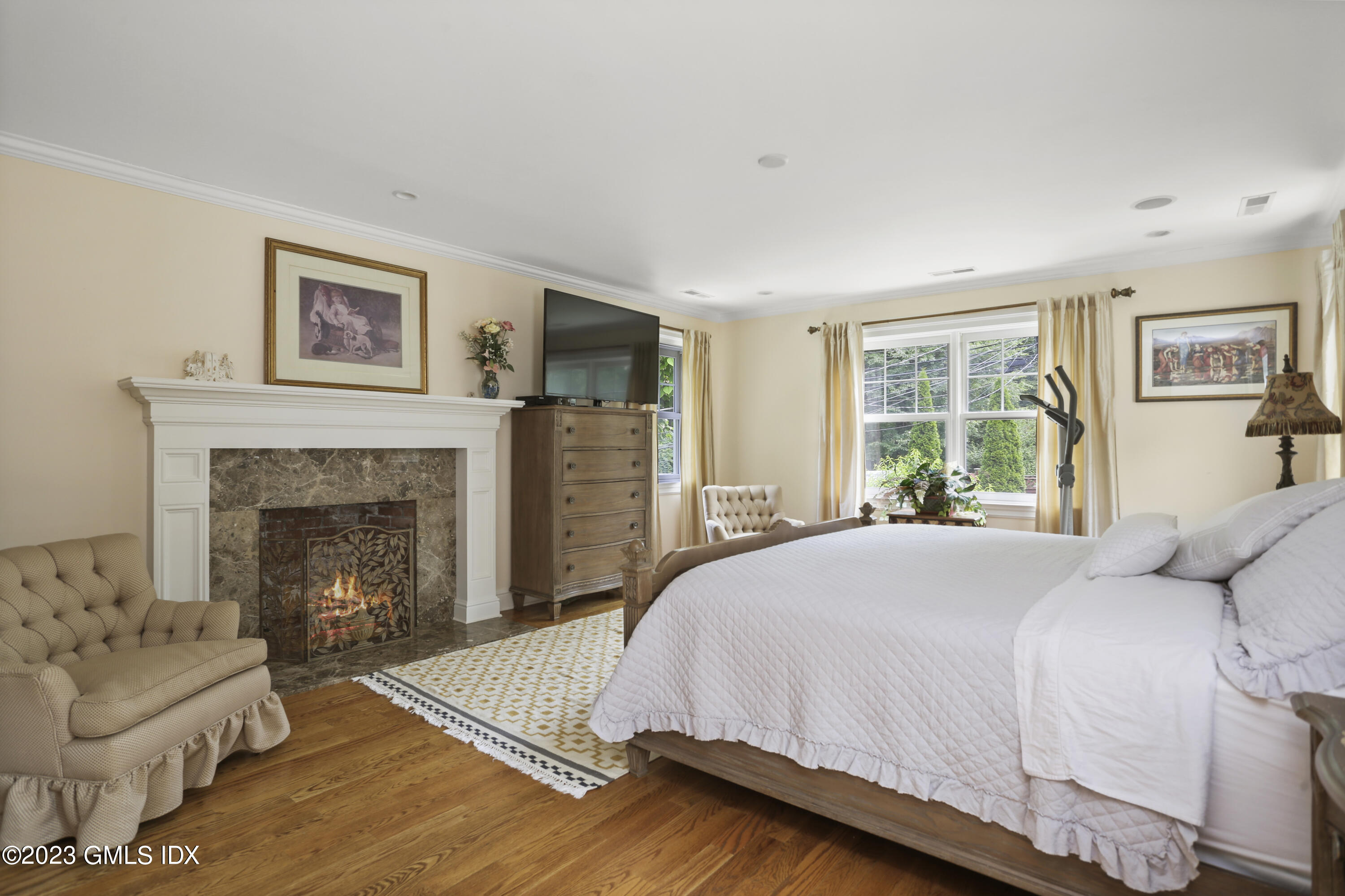 80 Brookside Drive Greenwich, CT 06831 - Photo 11 of 29 a bed room with a bed and a fireplace