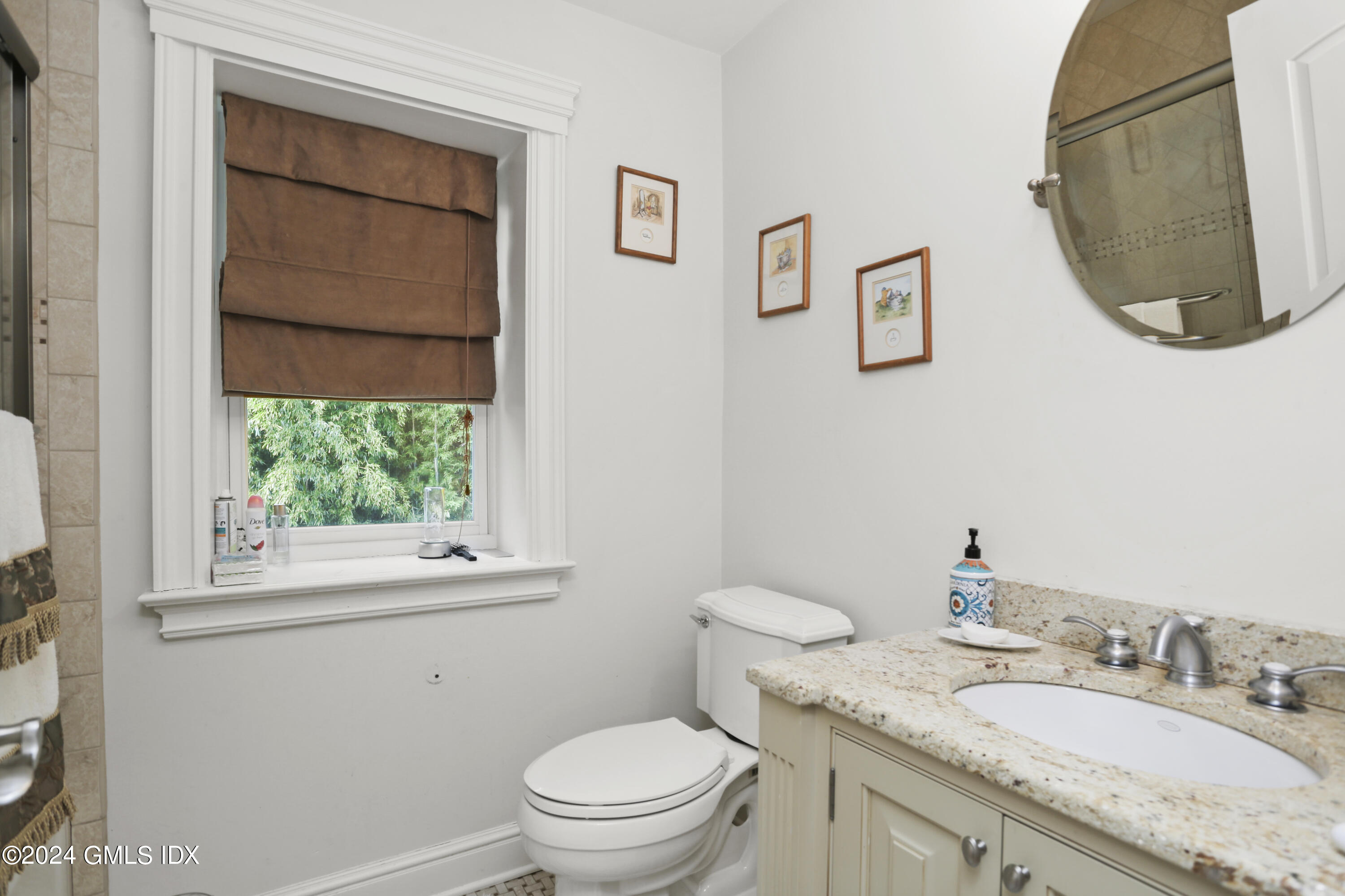 80 Brookside Drive Greenwich, CT 06831 - Photo 17 of 29 a bathroom with a granite countertop toilet a sink and a mirror