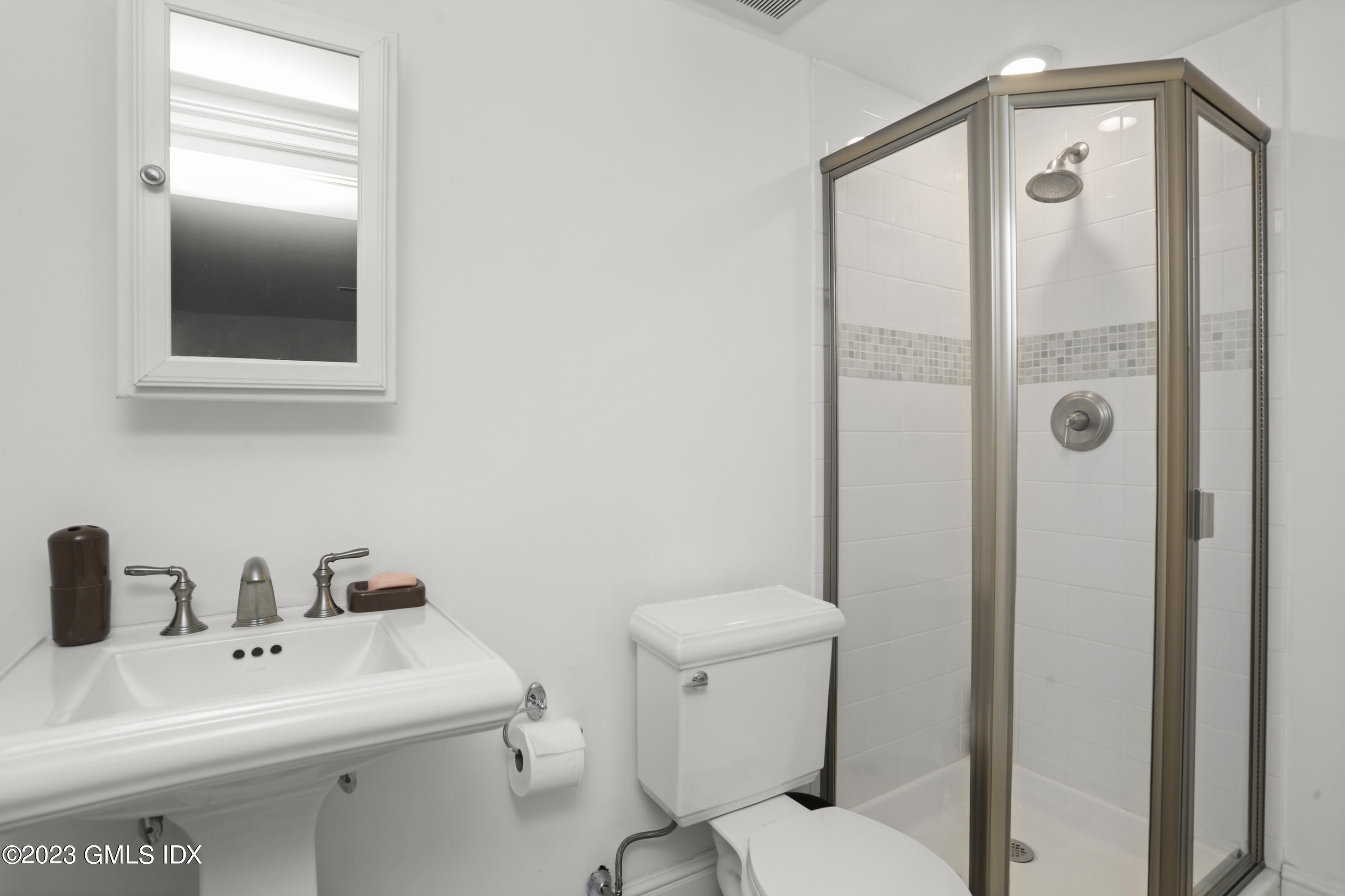 80 Brookside Drive Greenwich, CT 06831 - Photo 21 of 29 a bathroom with a sink a toilet and shower