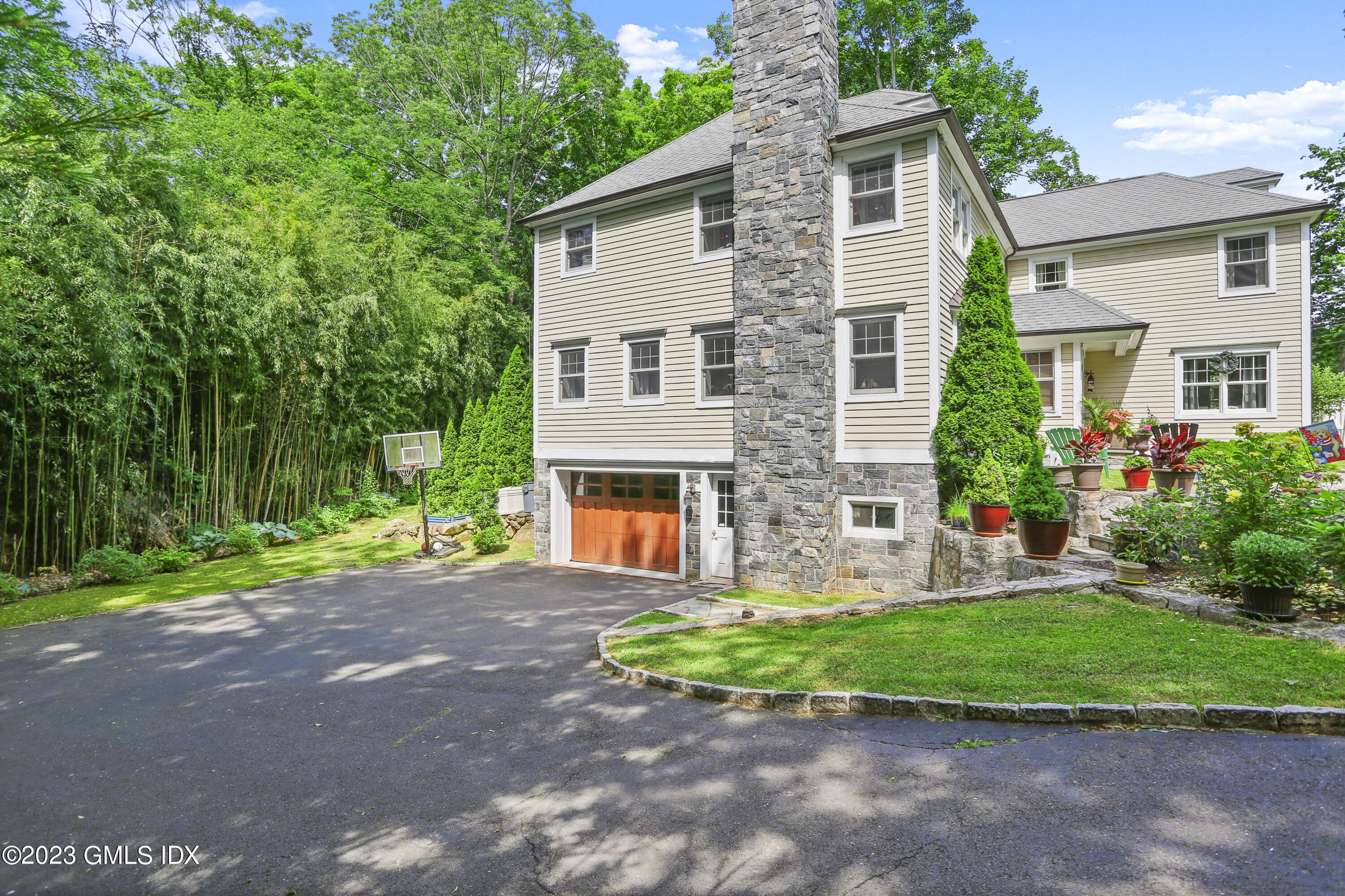 80 Brookside Drive Greenwich, CT 06831 - Photo 26 of 29 a front view of a house with a garden and plants
