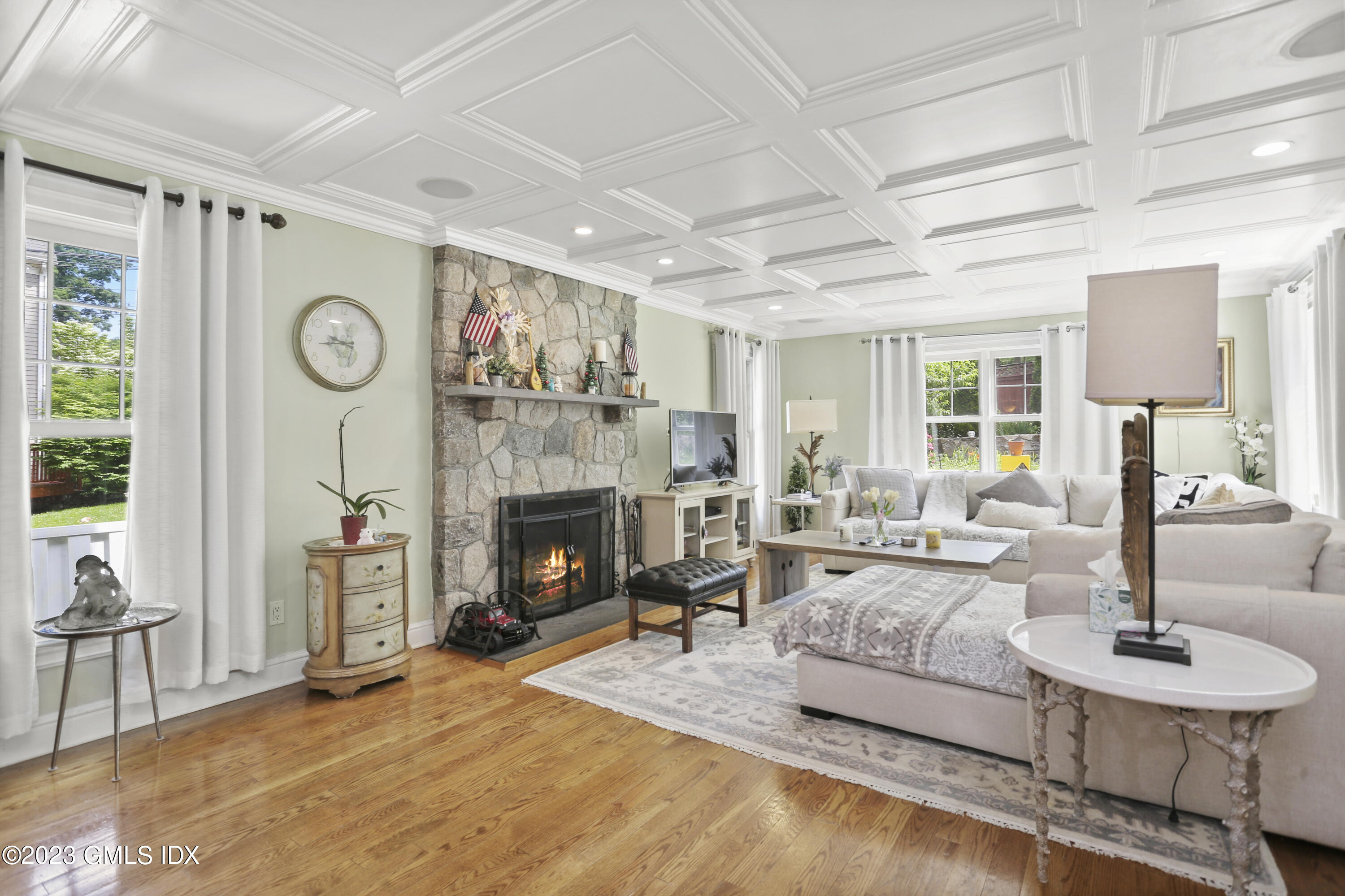 80 Brookside Drive Greenwich, CT 06831 - Photo 7 of 29 a living room with furniture a clock and a fireplace