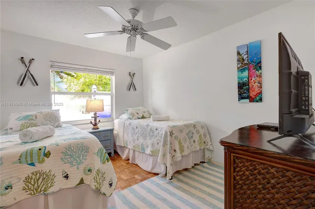 a bedroom with two beds and a window