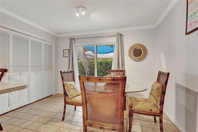 a view of a dining room with furniture and a window