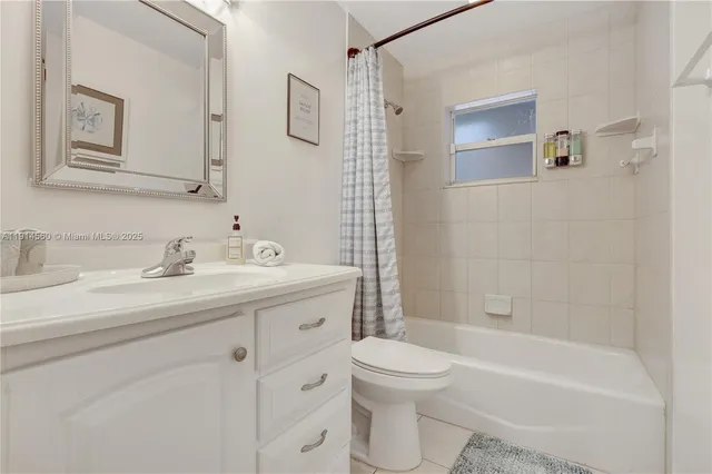 a bathroom with a double vanity sink toilet and a mirror