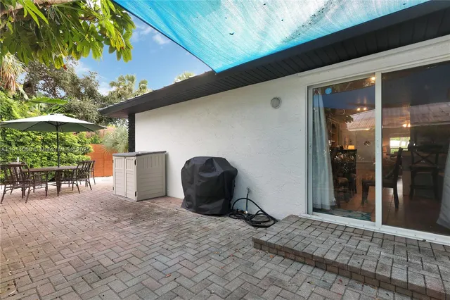 a patio with a patio table and chairs