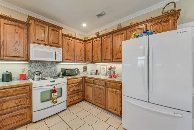 a kitchen with a white cabinets and white appliances