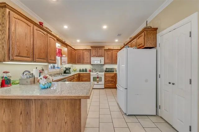 a kitchen with stainless steel appliances granite countertop a refrigerator sink and cabinets