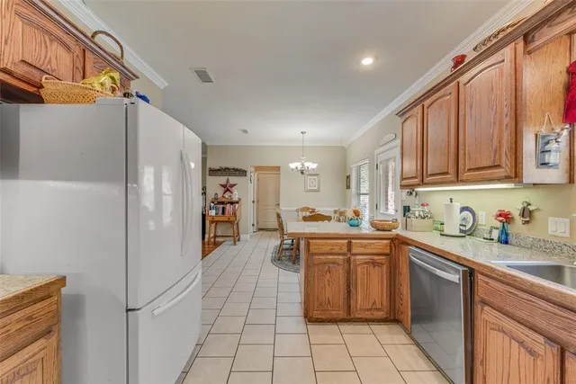 a kitchen with stainless steel appliances granite countertop a sink and cabinets