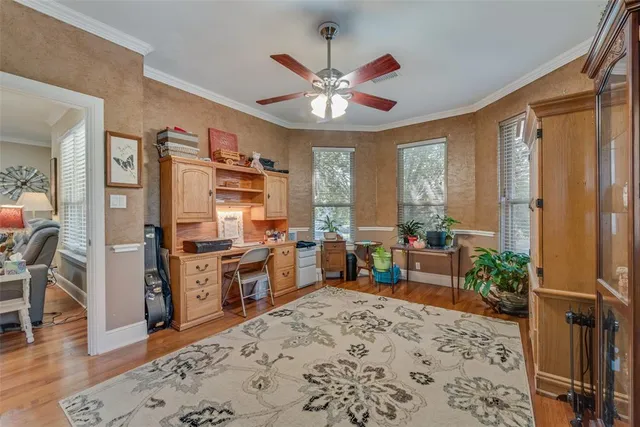 a kitchen with stainless steel appliances a stove a refrigerator a sink dishwasher with a dining table and chairs with wooden floor