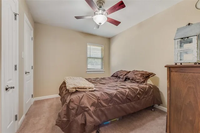 a bedroom with bed and a window