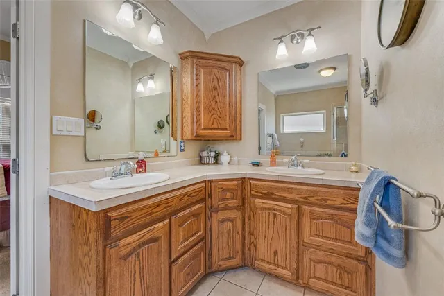 a bathroom with a sink double vanity and a mirror