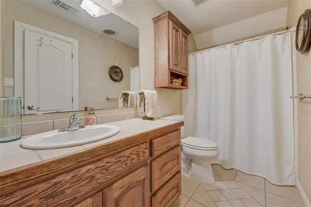 a bathroom with a sink toilet and a mirror