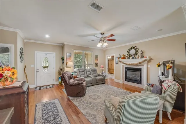a living room with furniture a fireplace and a chandelier
