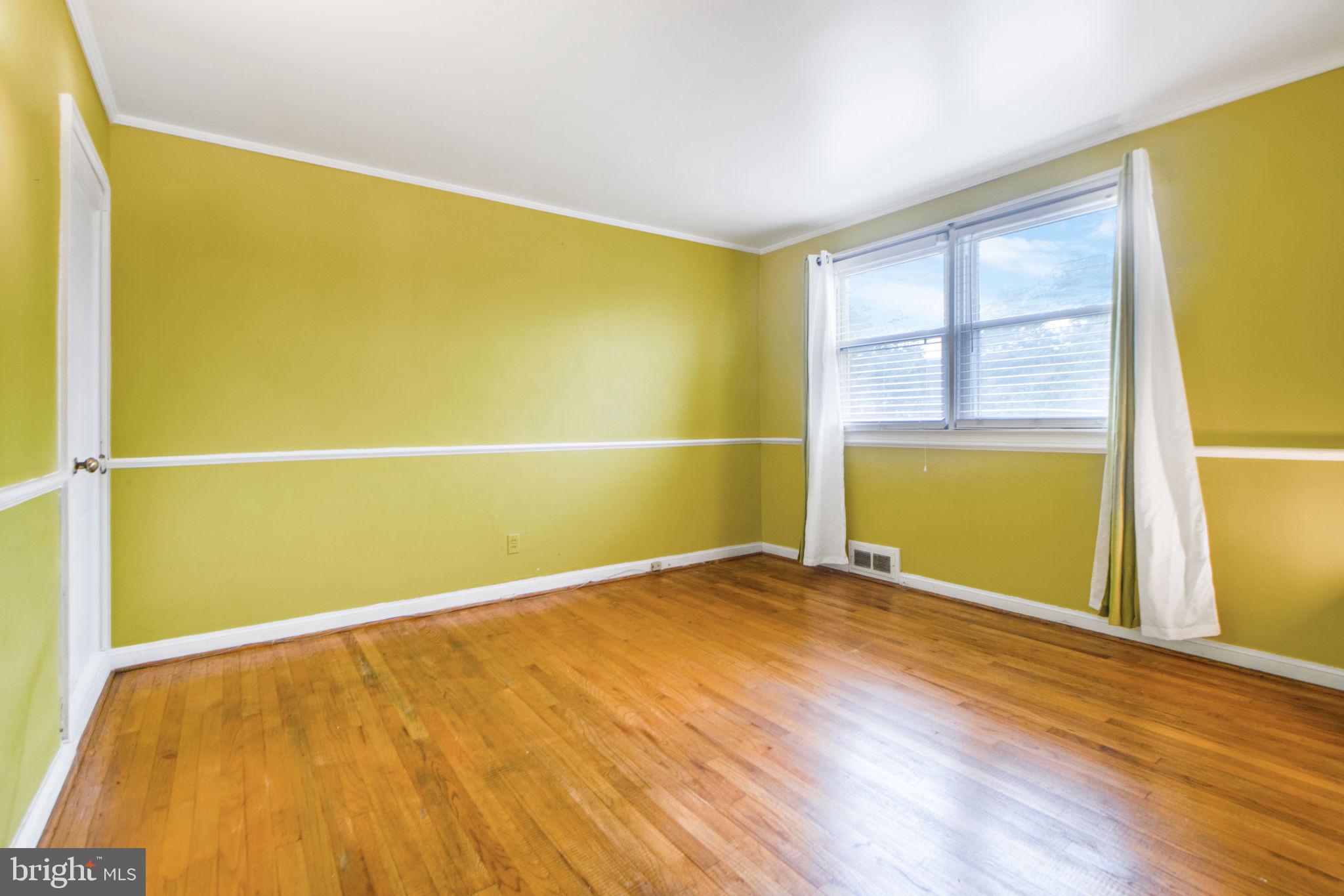 1903 Heathfield Road Baltimore, MD 21239 - Photo 16 of 30 a view of an empty room with wooden floor and a window
