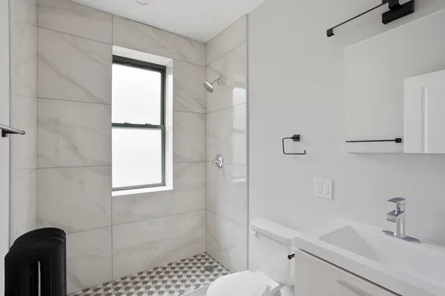 a bathroom with a sink toilet and shower