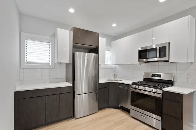 a kitchen with a refrigerator stove and microwave