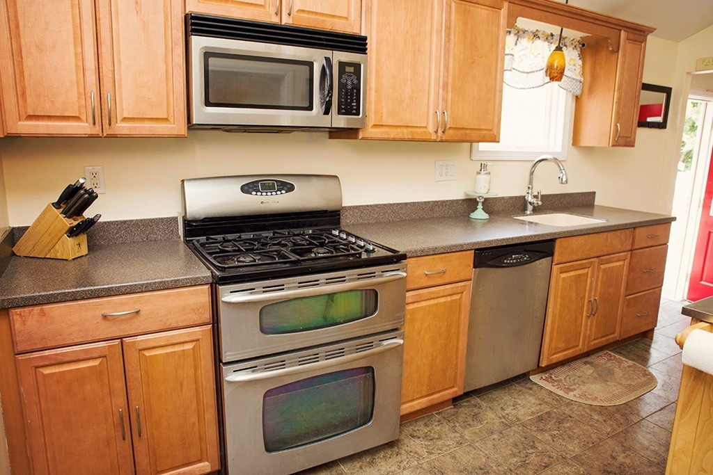 91 Lafayette Road Salisbury, MA 01952 - Photo 3 of 17 a kitchen with stainless steel appliances granite countertop a stove a microwave and a sink