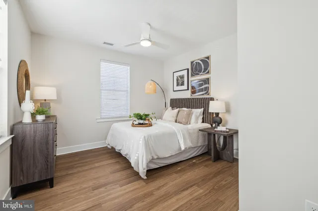 a bedroom with a bed and wooden floor