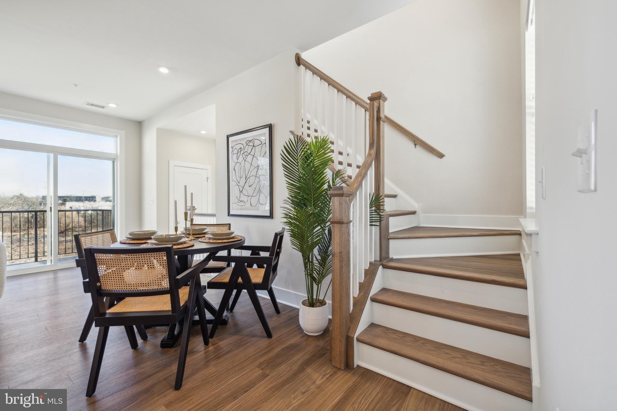 17 Mainland Road, Unit 216 Harleysville, PA 19438 - Photo 13 of 23 a view of a dining room with furniture and wooden floor