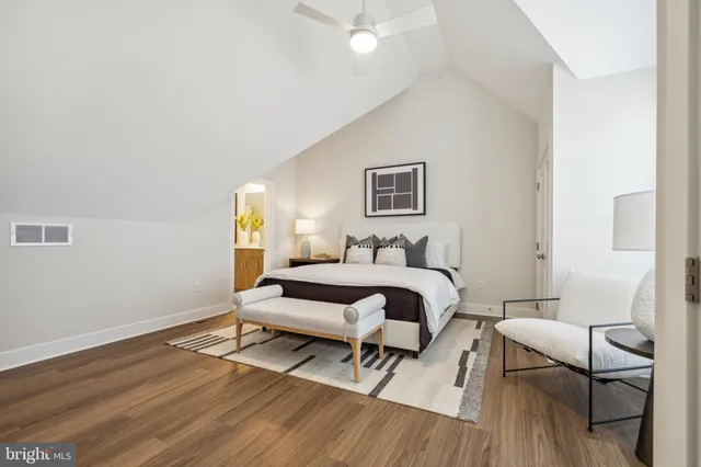 a bedroom with a large bed and a flat screen tv