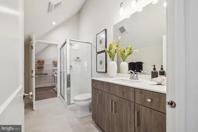 a bathroom with a sink a toilet and mirror