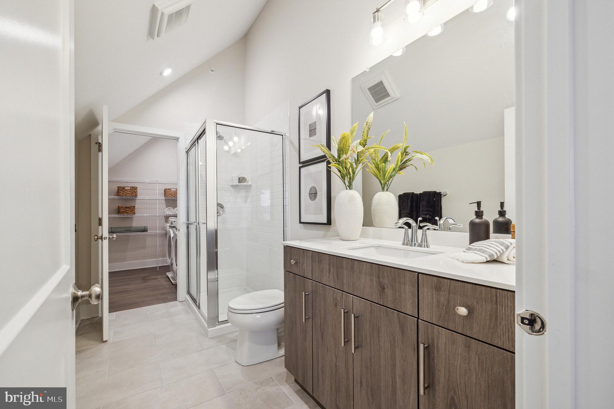 17 Mainland Road, Unit 216 Harleysville, PA 19438 - Photo 21 of 23 a spacious bathroom with a granite countertop sink mirror and toilet