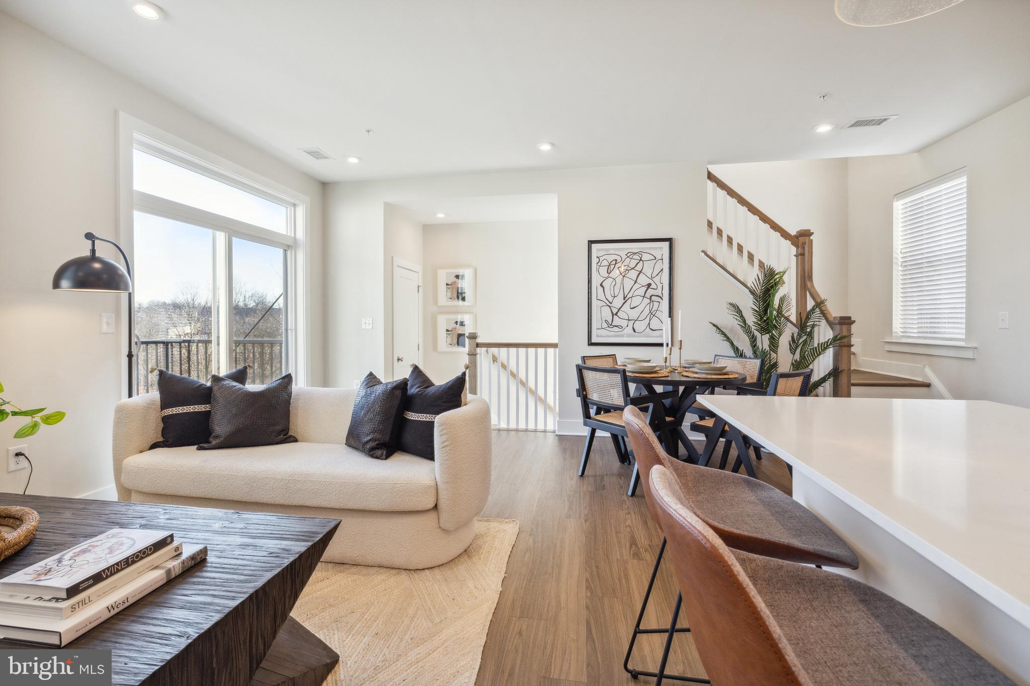 17 Mainland Road, Unit 216 Harleysville, PA 19438 - Photo 23 of 23 a living room with furniture floor to ceiling window and wooden floor