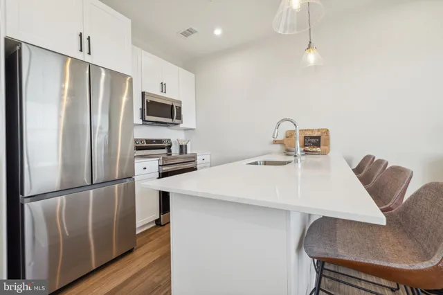 a living room with furniture floor to ceiling window and wooden floor