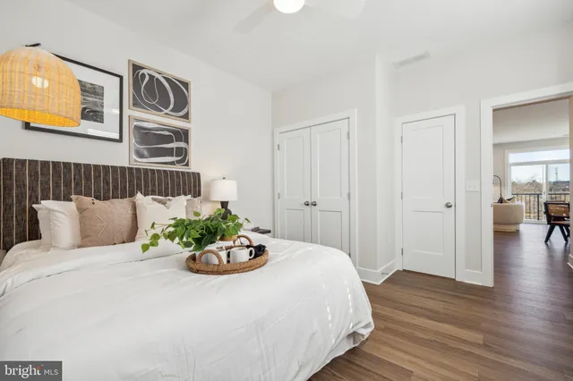 a kitchen with stainless steel appliances a dining table chairs and a refrigerator