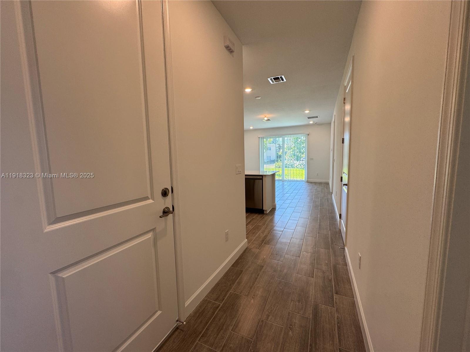 5726 Divine Drive, Unit 5726 Delray Beach, FL 33484 - Photo 14 of 44 a view of a hallway with wooden floor and staircase