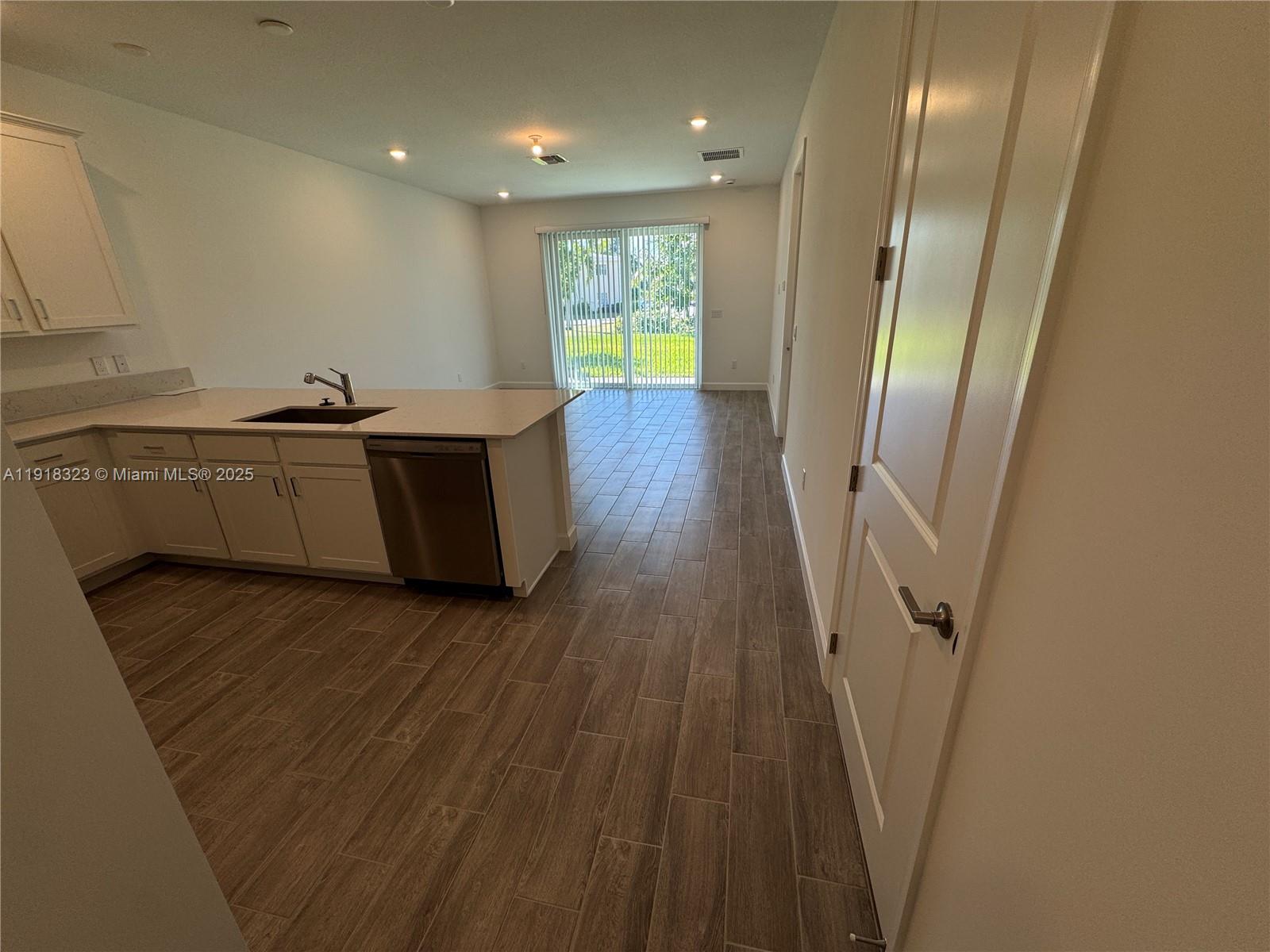 5726 Divine Drive, Unit 5726 Delray Beach, FL 33484 - Photo 17 of 44 a hallway with wooden floor and staircase