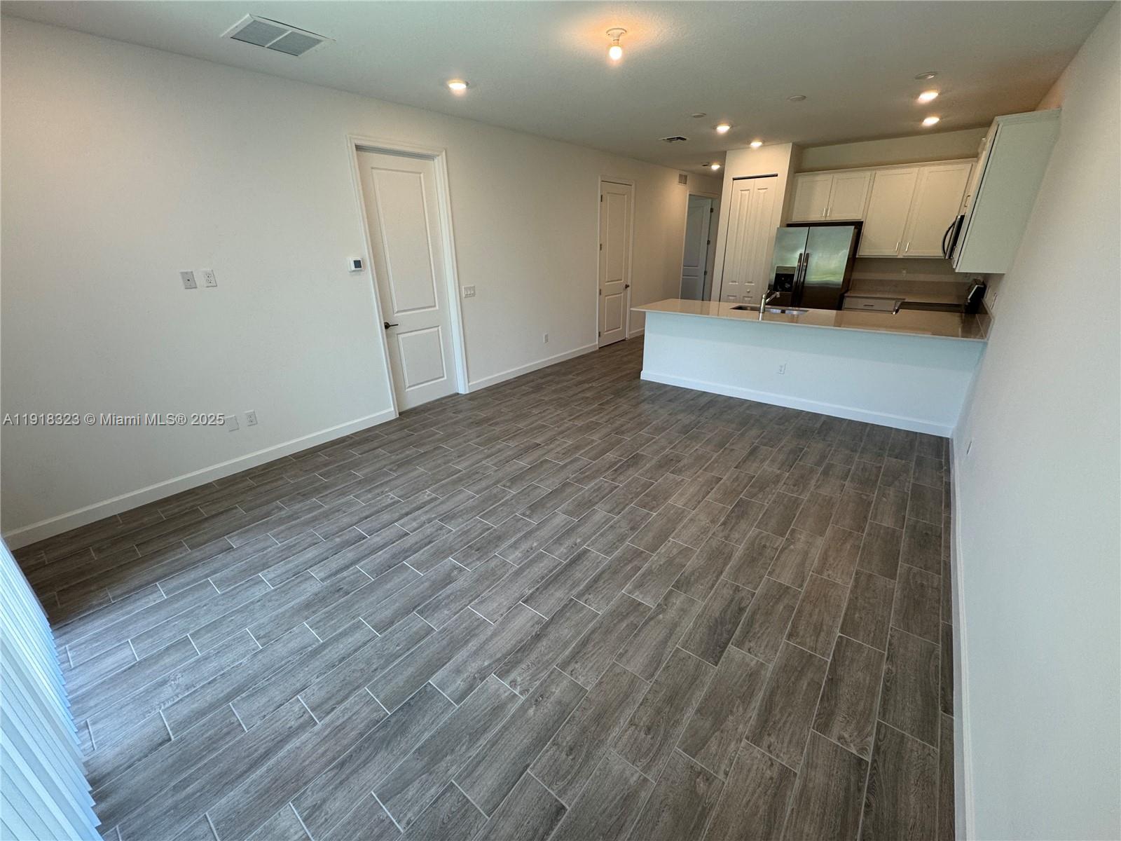 5726 Divine Drive, Unit 5726 Delray Beach, FL 33484 - Photo 24 of 44 a view of a kitchen with cabinets and wooden floor