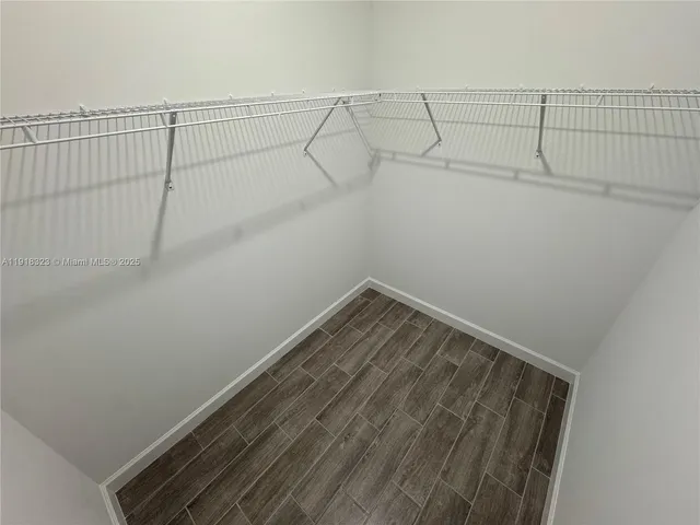 a spacious bathroom with double vanity and mirrors