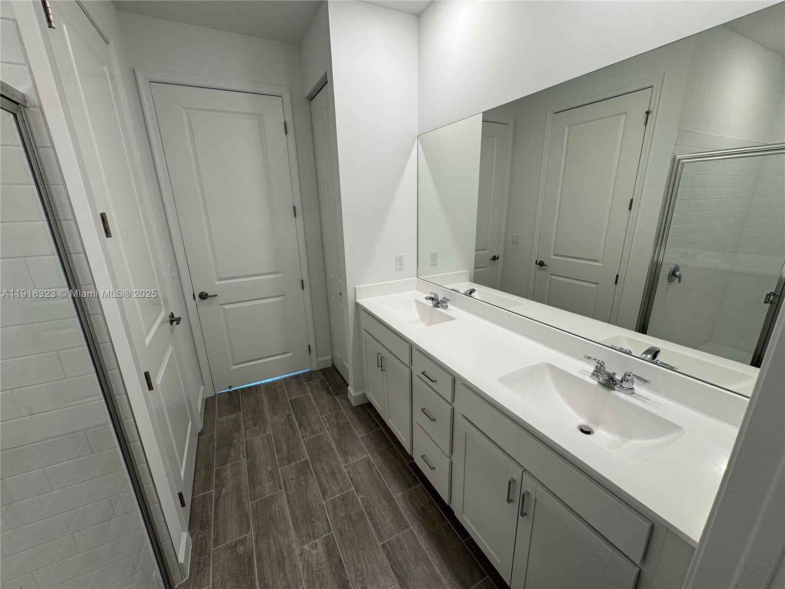 5726 Divine Drive, Unit 5726 Delray Beach, FL 33484 - Photo 38 of 44 a spacious bathroom with double vanity and mirrors