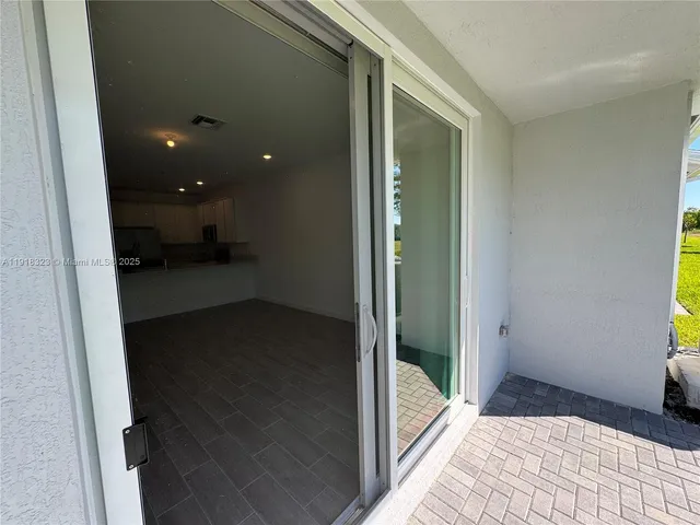 a view of a backyard with plants and patio