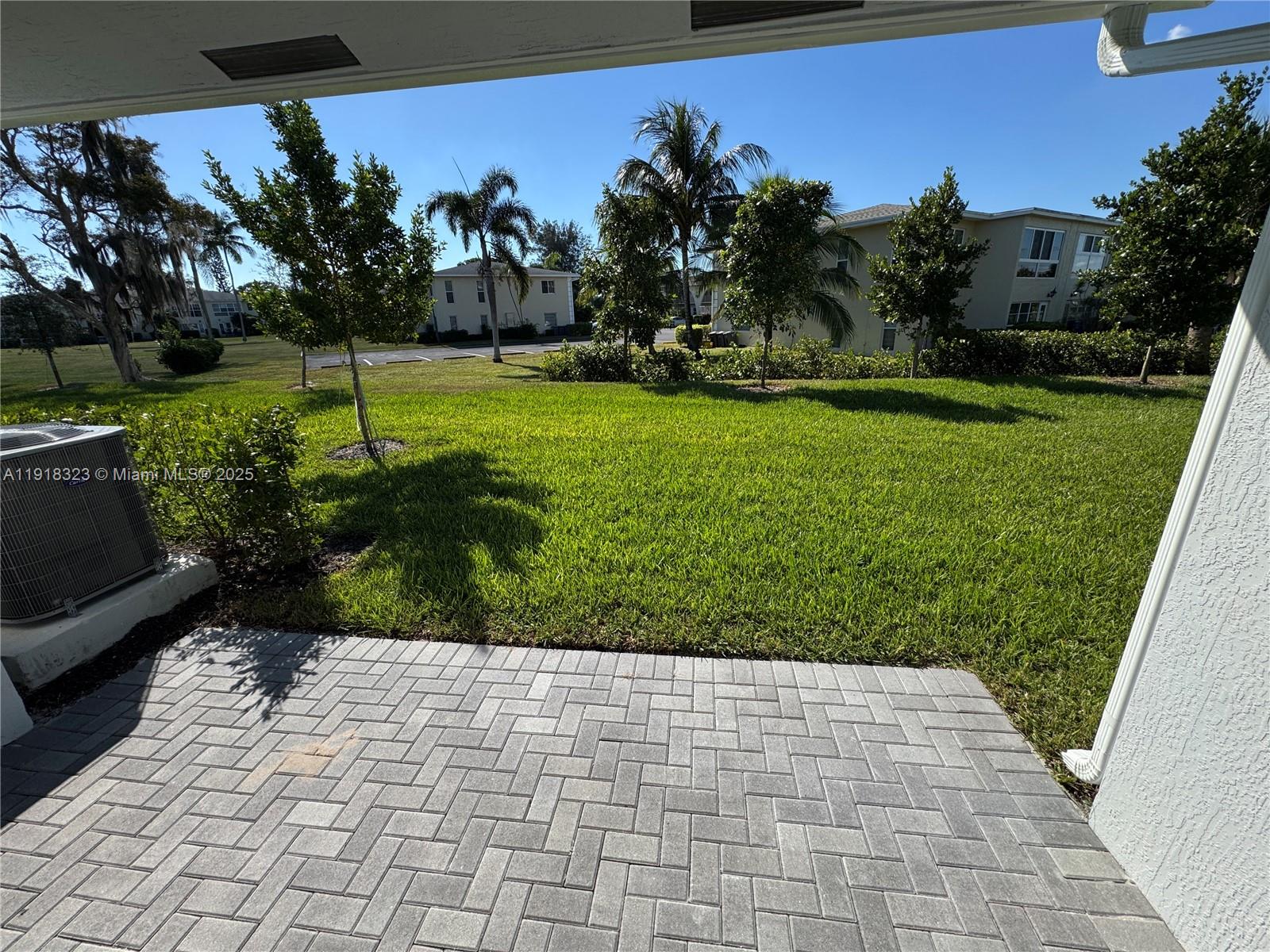 5726 Divine Drive, Unit 5726 Delray Beach, FL 33484 - Photo 41 of 44 a view of a garden with a flower in a yard