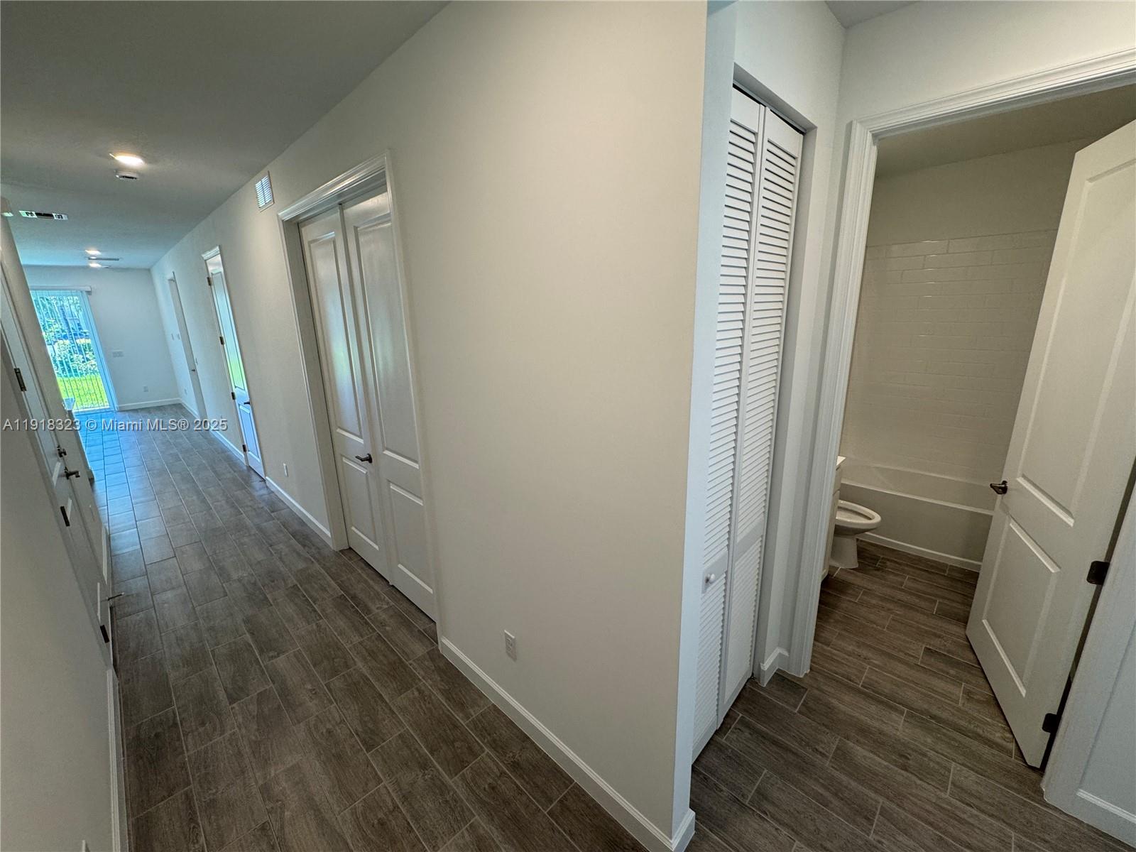 5726 Divine Drive, Unit 5726 Delray Beach, FL 33484 - Photo 6 of 44 a view of a hallway with wooden floor and staircase