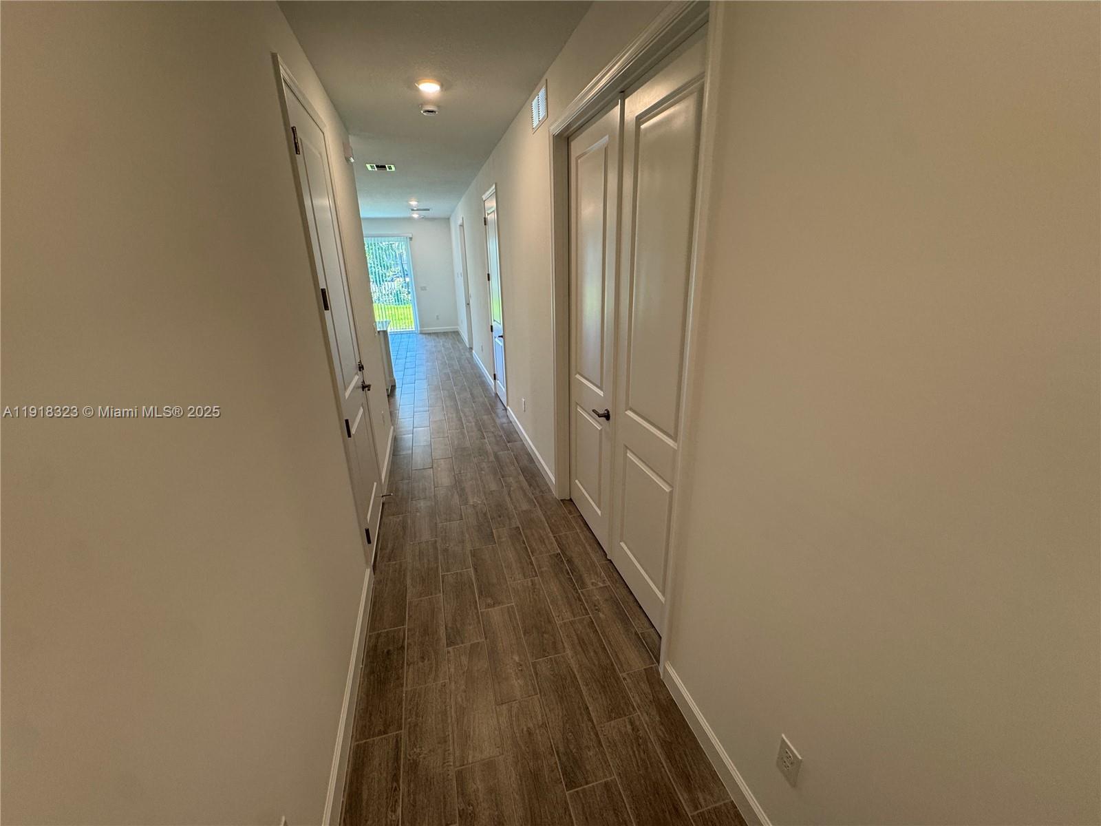5726 Divine Drive, Unit 5726 Delray Beach, FL 33484 - Photo 10 of 44 a view of a hallway with wooden floor